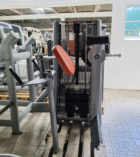 Gym80 standing buttock machine, gluteus machine, glutes kick radial, Sygnum series, silver frame, orange upholstery, used - refurbished condition