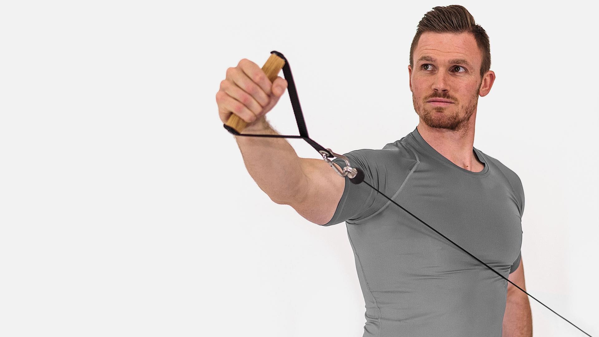 Person trainiert mit Fitnessgerät, hält Griff mit Seilzug.