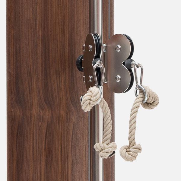 Seilzug an Fitnessgerät mit Holzverkleidung und Metallteilen.