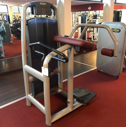 TechnoGym Gluteus Machine, Glute, Selection Line - New model with plastic cover, brown upholstery, used - refurbished condition