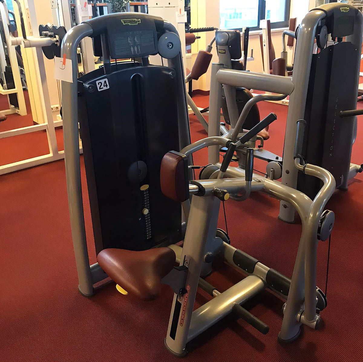 TechnoGym Low Row, Rowing, Lat Isolator, Selection Line - New model with plastic cover, brown upholstery, used - refurbished condition
