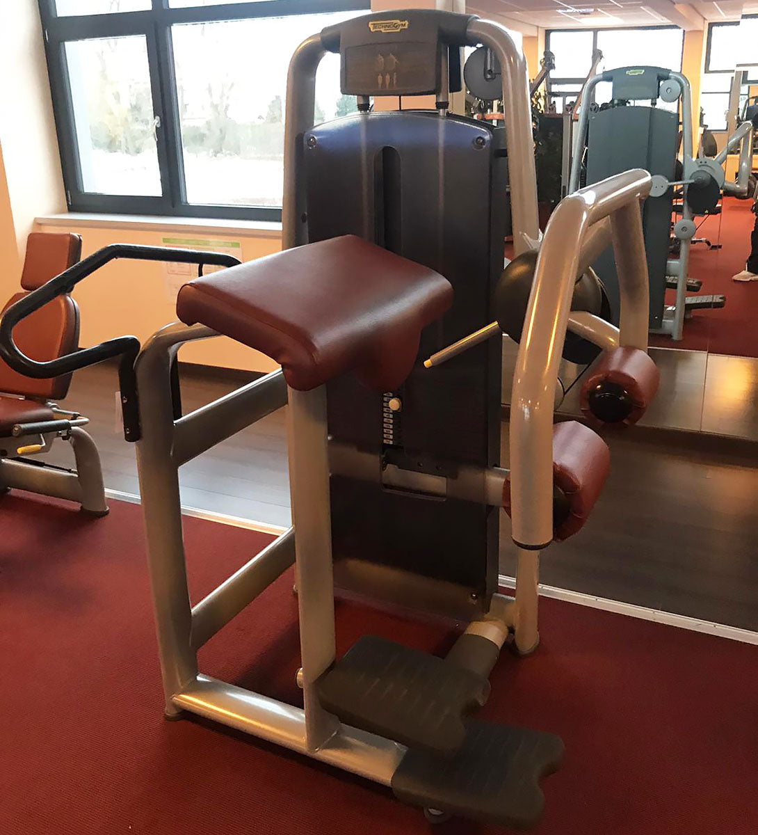 TechnoGym Gluteus Machine, Glute, Selection Line - New model with plastic cover, brown upholstery, used - refurbished condition