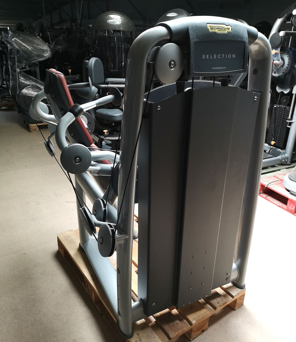 TechnoGym Triceps Machine, Arm Extension, Selection Line - New model with plastic cover, brown upholstery, used - refurbished condition