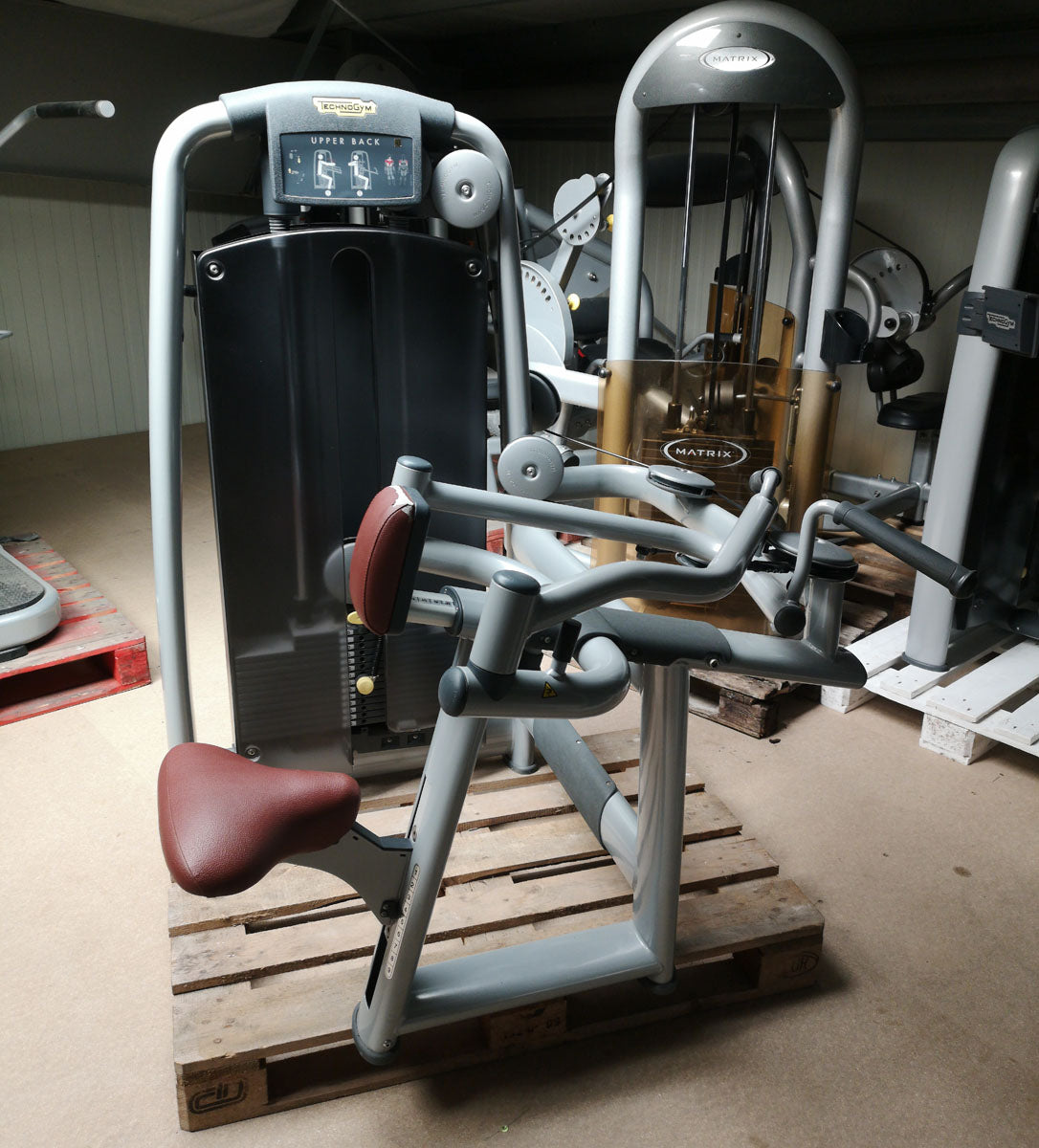 TechnoGym Upper Back, Rowing Row, Lat Isolator, Selection Line - New model with plastic cover, brown upholstery, used - refurbished condition